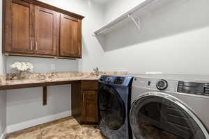 Laundry area with washer and clothes dryer and cabinet space