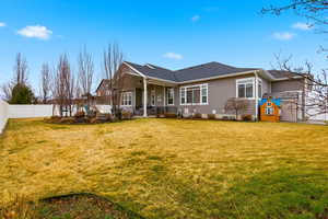 Rear view of property featuring a patio, a fenced backyard, and a shingled roof