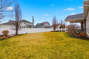 Fenced backyard featuring a residential view