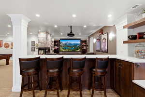 Bar featuring open shelves, recessed lighting, dark wood finish cabinets, light stone counters, and pool table