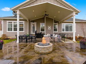 View of patio / terrace with an outdoor fire pit, a ceiling fan, and outdoor lounge area