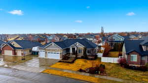 Craftsman inspired home with board and batten siding, a garage, stone siding, concrete driveway, and a residential view