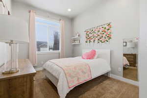 Carpeted bedroom featuring baseboards