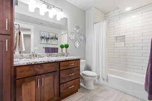 Full bath with vanity and shower / bath combo