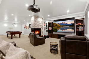 Cinema featuring crown molding, a fireplace, light carpet, billiards, and recessed lighting