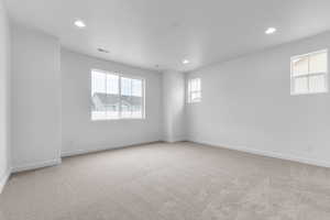 Unfurnished room with light carpet and recessed lighting