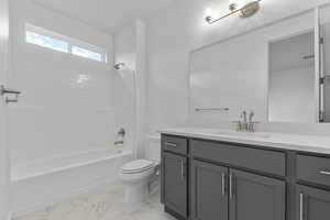 Bathroom with vanity, shower / bath combination, and light marble finish flooring