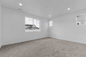 Unfurnished room featuring carpet flooring and recessed lighting