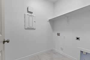 Laundry room featuring washer hookup, light marble finish floors, and electric dryer hookup