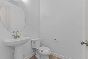 Bathroom featuring toilet and light wood-style flooring