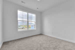 Unfurnished room with light carpet and baseboards