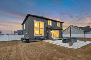 Back of house featuring outdoor lounge area, stucco siding, a fenced backyard, a patio area, and entry steps