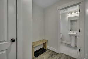 Bathroom featuring light wood-type flooring and baseboards