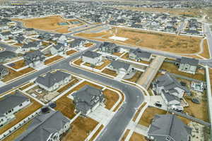 Aerial view of property and surrounding area featuring nearby suburban area