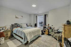 Bedroom featuring light colored carpet