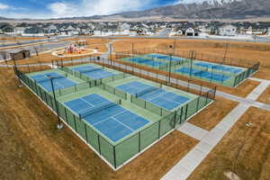 View of tennis court with a mountain view and a residential view