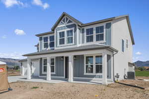 View of front of house featuring a mountain view, a porch, board and batten siding, and roof with shingles