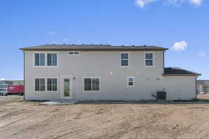 Back of house featuring a patio area and stucco siding