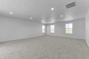 Spare room with light carpet and recessed lighting