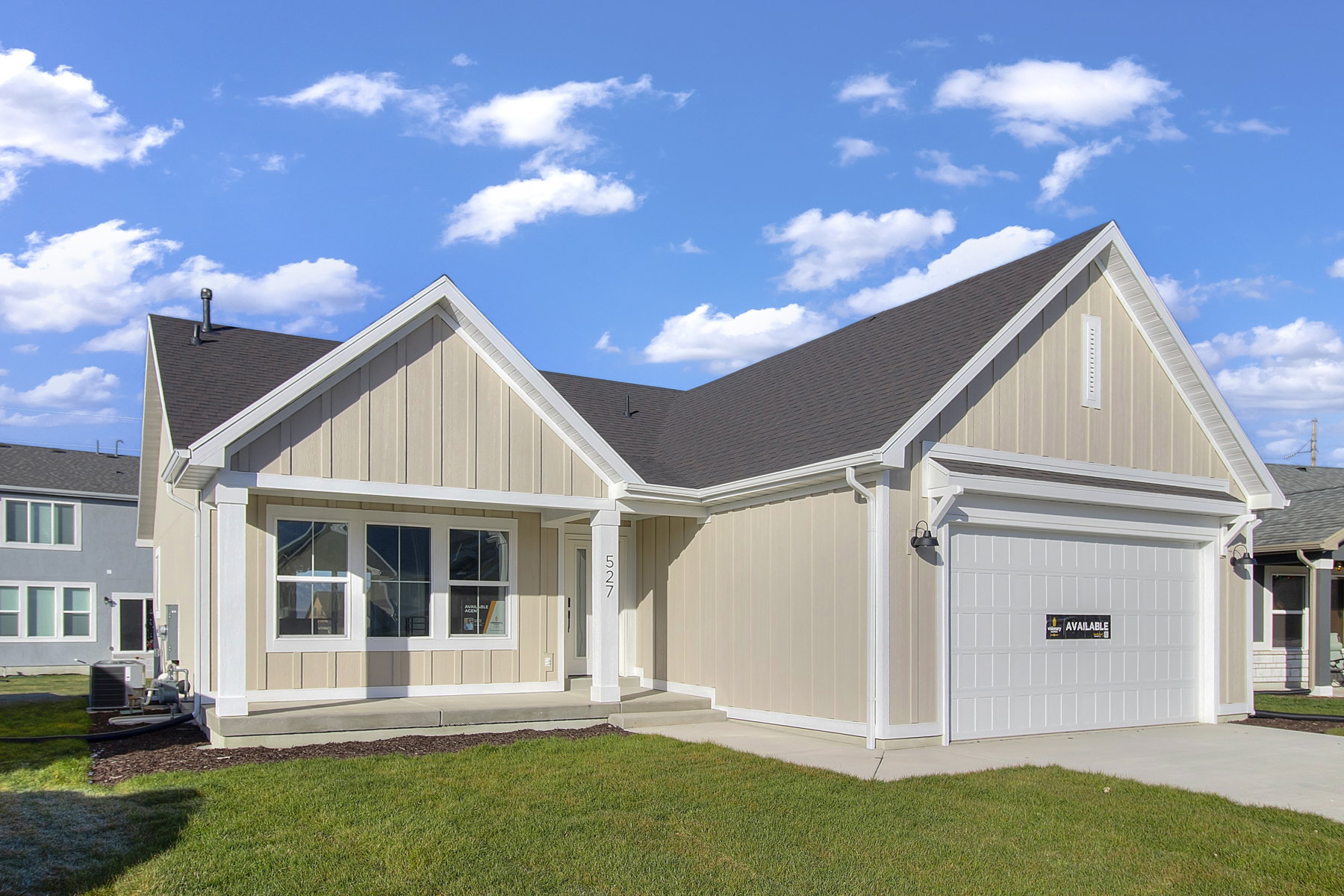 View of front facade with a front lawn, a garage, a porch, and a shingled roof