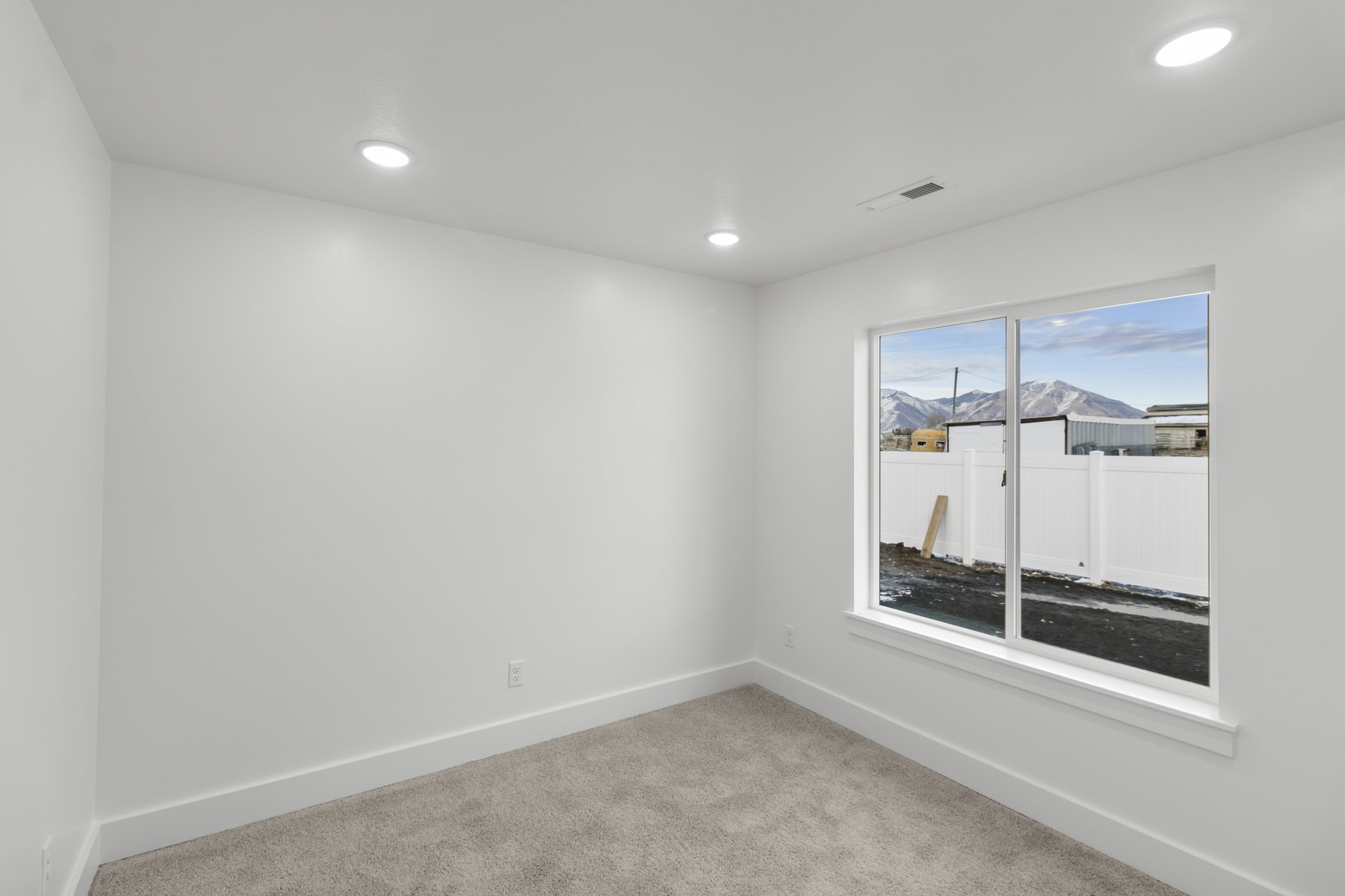 Empty room featuring light colored carpet and recessed lighting
