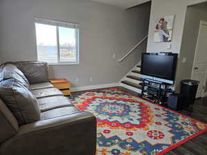 Living room featuring stairway and dark wood finished floors