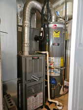 Utility room with gas water heater and heating unit