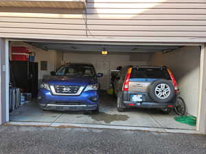 Garage featuring 2 car, Utility room and electric panel