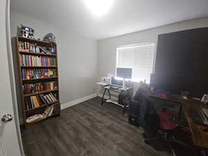 Fourth bedroom or Office with dark wood finished floors and baseboards