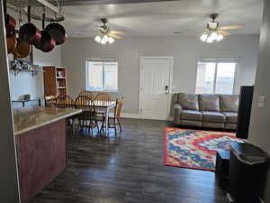 Dining room with a ceiling fan, dark wood finished floors, and a textured ceiling
