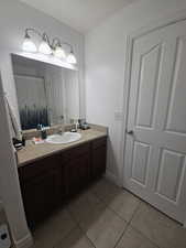 Primary Full bath with vanity, light tile patterned floors, and curtained shower