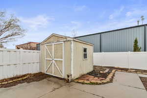 View of shed with vinyl privacy fencing