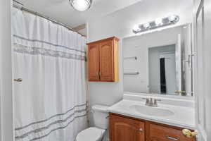 Full bathroom featuring a shower, vanity, and tile floors