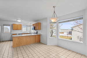 Kitchen, dining area, door to backyard and deck with gas grill perfect for evening dinners