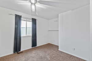Bedroom 1 with walk-in closet, carpet flooring and ceiling fan