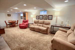 Living room featuring recessed lighting and light carpet