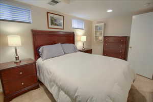 Bedroom featuring light colored carpet