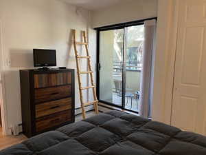 Bedroom with access to outside and baseboard heating