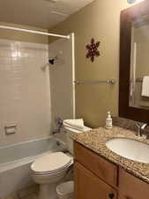 Full bathroom featuring vanity,  shower combination, and tile patterned flooring