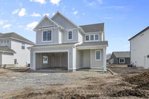 View of front of home featuring board and batten siding, a garage, a patio area, roof with shingles, and driveway