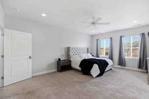 Bedroom featuring light carpet, a ceiling fan, and recessed lighting