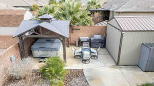 View of parking featuring a fenced backyard and a shed