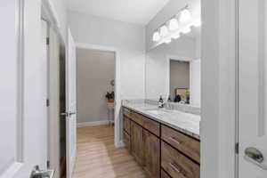 Bathroom featuring vanity and light wood finished floors