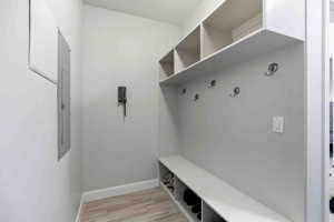 Mudroom with baseboards and light wood-type flooring