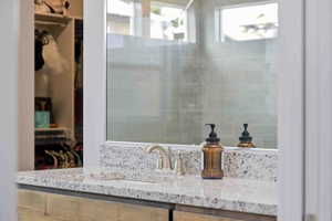 Bathroom with vanity and a spacious closet