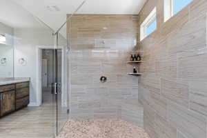 Bathroom with a shower stall and vanity