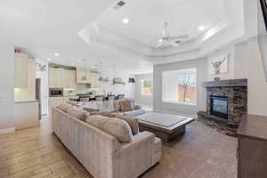 Living area featuring ceiling fan, recessed lighting, a fireplace, and wood tiled floors