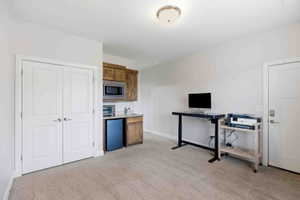 Office with light colored carpet and baseboards