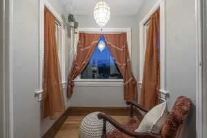 Sitting room with wood finished floors and baseboards