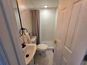 Loft Bathroom featuring a stall shower and tile patterned flooring